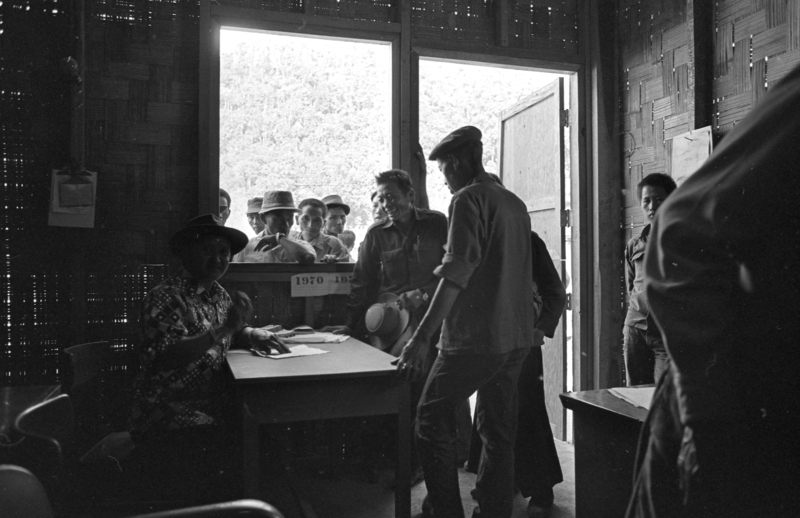 Hmong men in a makeshift supply office in 1971. 